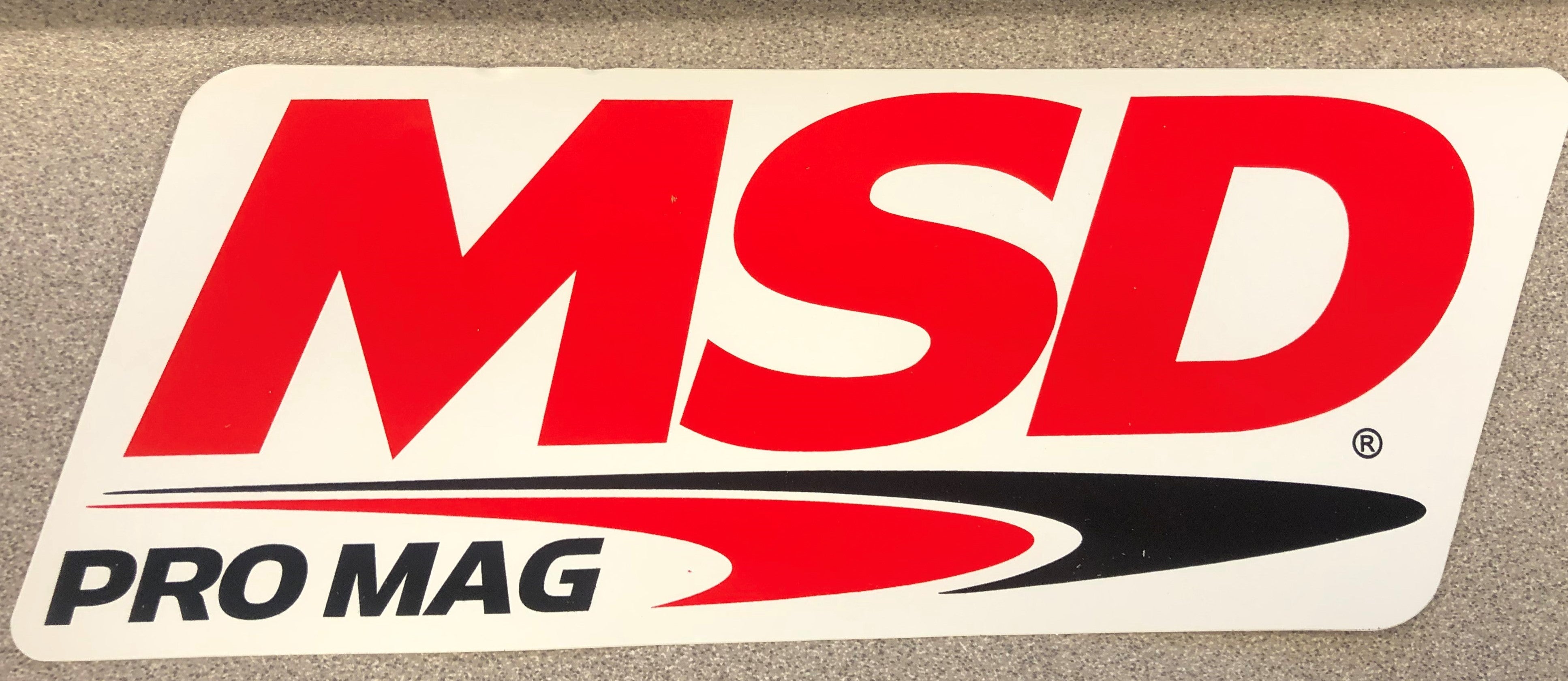 The MSD PRO MAG Logo Decal; Red, Black & White. 9.25" wide x 3.375" high.