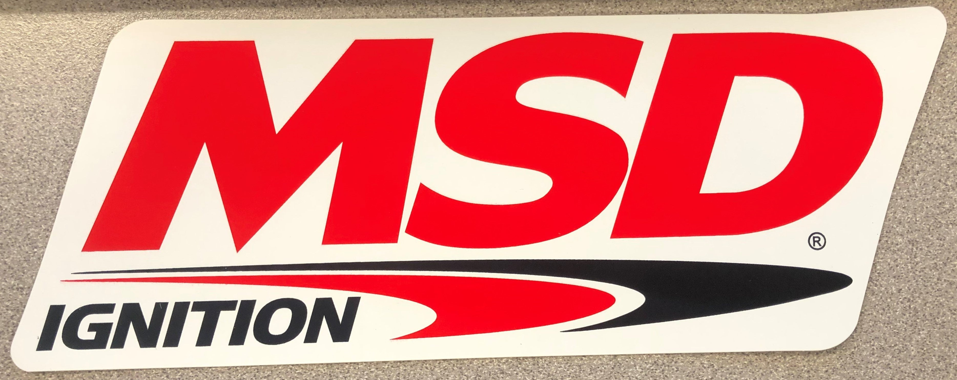 The MSD Logo Decal, Red, Black & White. 9.25" wide x 3.375" high.